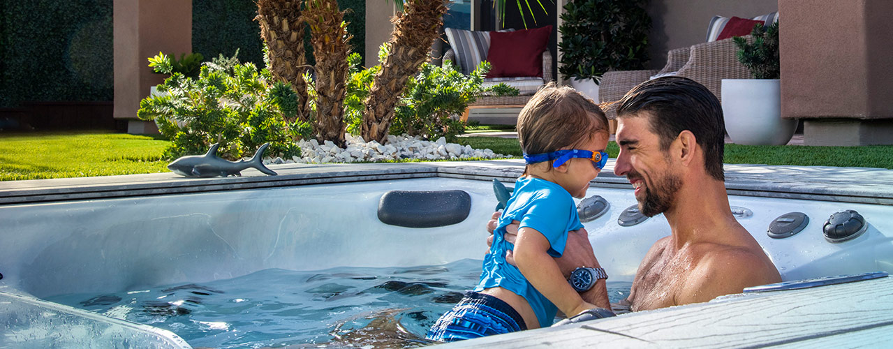 Michael Phelps with his son Boomer in a Michael Phelps swim spa