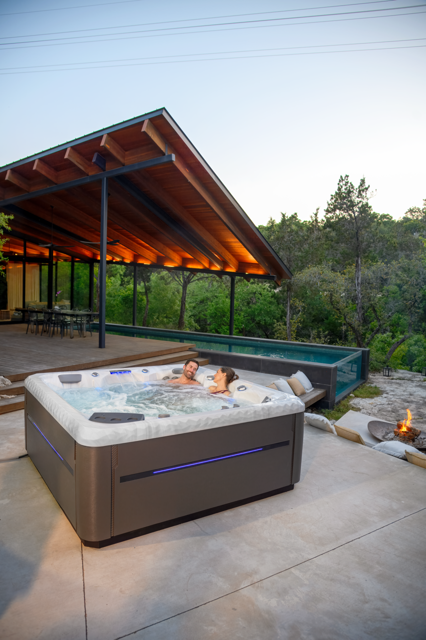 A couple relaxing in a Master Spas hot tub outdoors